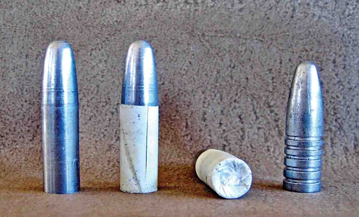 Left to right: Unpatched .40 caliber 465-grain swaged slug; the swaged slug patched; hollow base on the bullet; .40 caliber, 410-grain grease groove bullet for comparison.